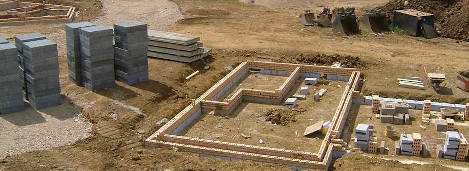 Site preparation, building foundations and first course of brickwork